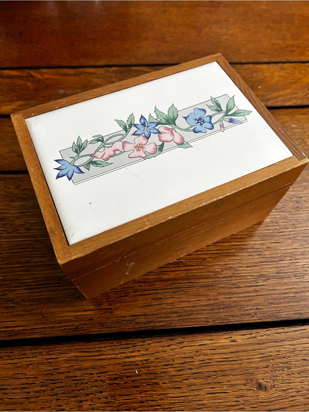 Wooden recipe box with floral ceramic lid with vintage recipes and receipts